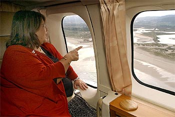 La ministra sobrevuela en helicóptero la costa gallega afectada por el vertido.