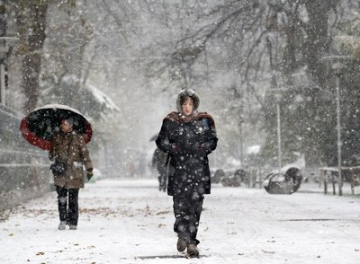 Una mujer cruza el parque de la Florida de Vitoria durante la nevada caída esta mañana.