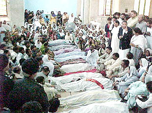 Los familiares de los fallecidos en el ataque a la iglesia, junto a los cadáveres en el tanatorio de Bahawalpur.