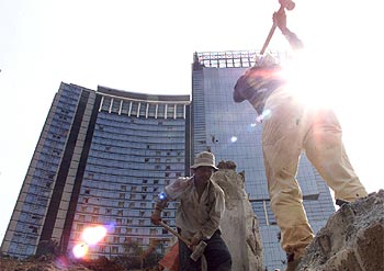 Unos operarios retiran los escombros ante el hotel Marriott de Yakarta.