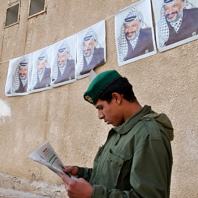 Uno de los guardias de Arafat en Ramala lee en la prensa palestina las noticias sobre la salud del líder de la ANP.