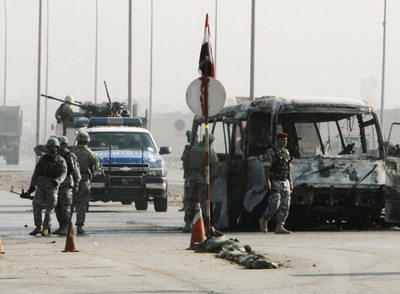 La policía iraquí inspecciona los restos del autobús objeto del ataque esta mañana en Bagdad