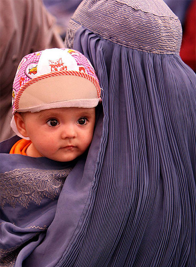 Un niño asiste con su madre a un acto electoral en Kabul