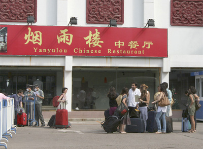 Algunos de los 16 estudiantes de la Universidad de Comillas abandonan el hotel donde han permanecido en cuarenta.